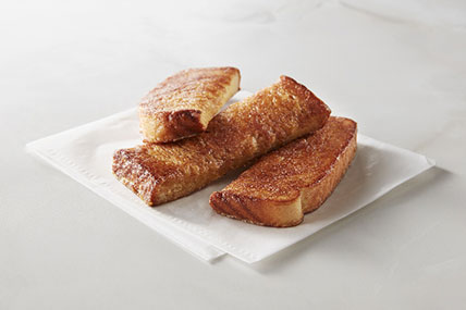 Crispy French toast sticks served with maple syrup for dipping