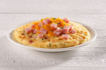 Skillet egg frittata with vegetables served in a cast iron pan