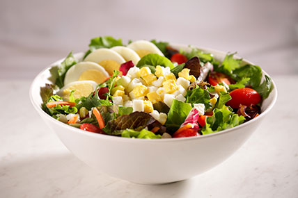 Fresh garden salad topped with diced hard cooked eggs